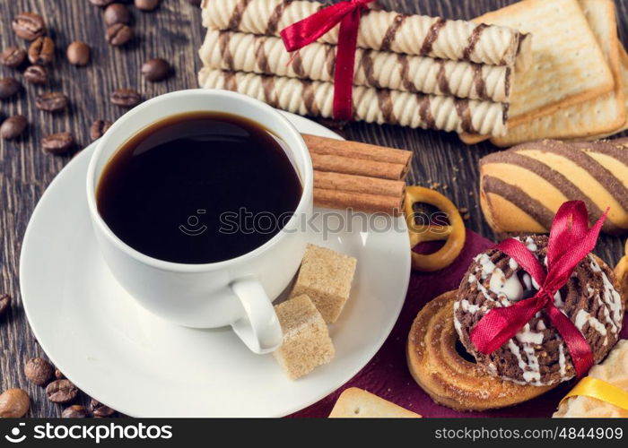 Biscuits and coffee on table. Assorted biscuits and sweets with a cup of coffee on table