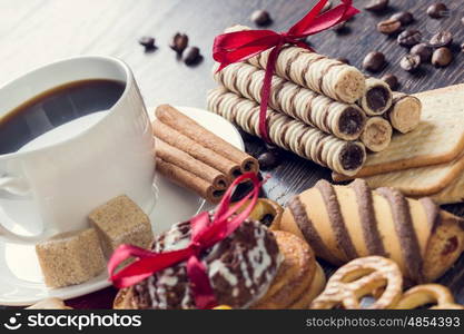 Biscuits and coffee on table. Assorted biscuits and sweets with a cup of coffee on table