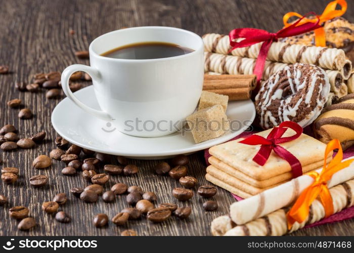 Biscuits and coffee on table. Assorted biscuits and sweets with a cup of coffee on table