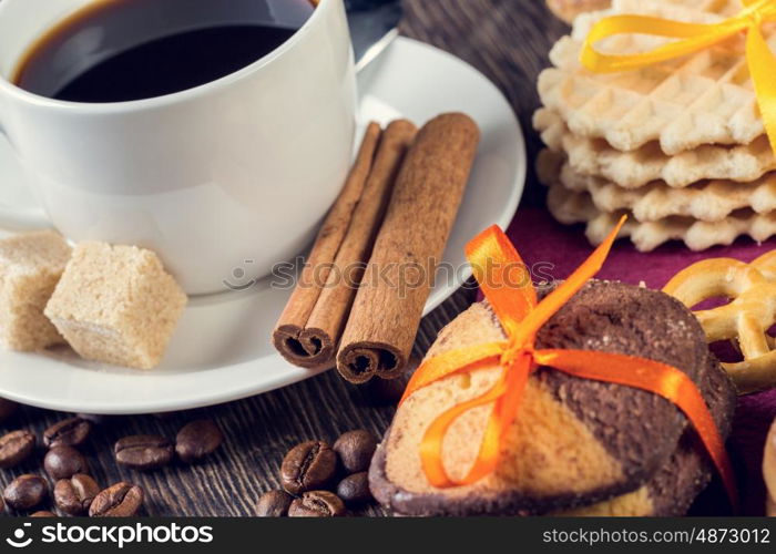 Biscuits and coffee on table. Assorted biscuits and sweets with a cup of coffee on table