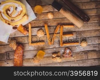 biscuits cake lying on a brown board rustic love shaped breakfast for Valentine&rsquo;s Day for lovers.