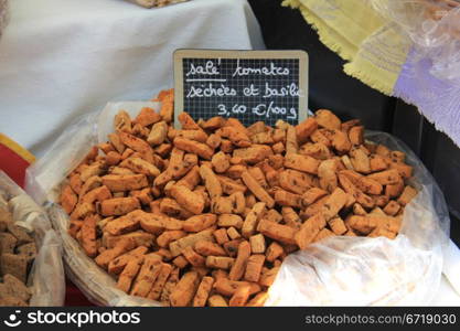 Biscuits with basil and dried tomato on a french market