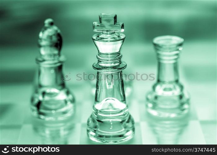 bishop, king, and rook chess pieces made out of glass