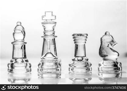 bishop, king, rook and knight chess pieces made out of glass
