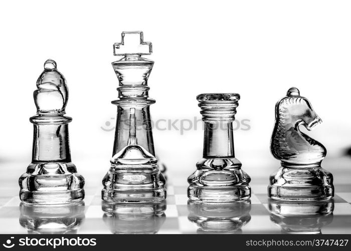 bishop, king, rook and knight chess pieces made out of glass