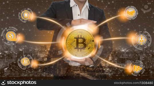 Bitcoin and cryptocurrency investing concept - Businessman holding Bitcoin with mobile application business icons showing exchanging, trading, transfer and investment of blockchain technology.