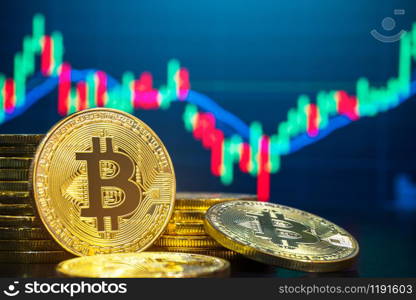 Bitcoin and cryptocurrency trading system concept - Image of Physical cryptography bitcoin pile against market price chart as blur background.