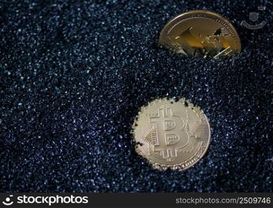 bitcoin and litecoin on blue sparkling granules, sand. electronic money. coins are bitcoin and litecoin