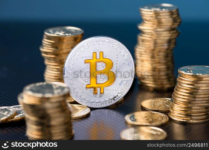 Bitcoin. Bitcoin coin bit golden bit sybmol logo with gold coins stacks.