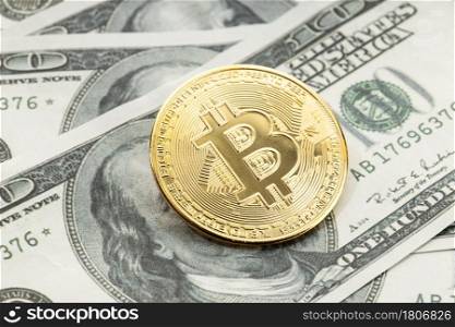 Bitcoin coin on dollar banknotes. Cryptocurrency on US dollar bills