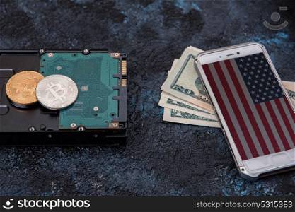 Bitcoin coin on HDD with smartphone with USA flag. Bitcoin coins concept