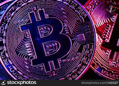Bitcoin coins in a mysterious lighting in an extreme close-up. Cryptocurrency. E-business.. Bitcoin coins in a mysterious lighting