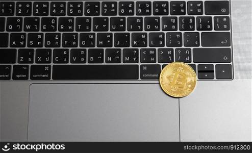 Bitcoin coins on a laptop keyboard