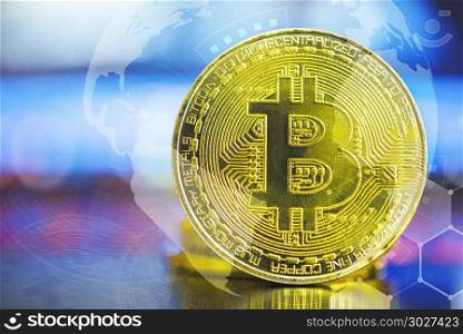 Bitcoin concept. Big golden bitcoin on blurred computer laptop s. Bitcoin concept. Big golden bitcoin on blurred computer laptop screen with technology icons background. Blockchain, cryptocurrencies. Picture for add text message. Backdrop for design art work.