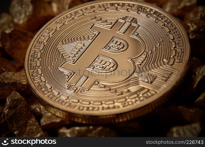 Bitcoin cryptocurrency as digital gold concept . Close up golden bitcoin token on mound of gold nuggets. Virtual currency background.. Close up golden bitcoin token on mound of gold nuggets. Cryptocurrency concept.