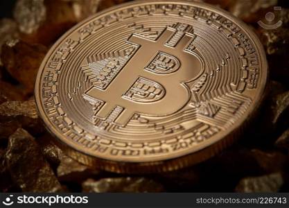 Bitcoin cryptocurrency as digital gold concept . Close up golden bitcoin token on mound of gold nuggets. Virtual currency background.. Close up golden bitcoin token on mound of gold nuggets. Cryptocurrency concept.