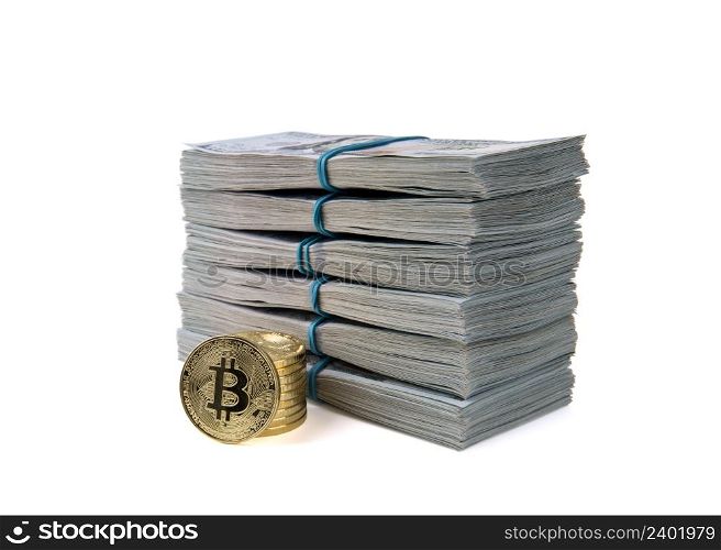 Bitcoin gold coins on US dollar bills.