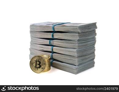 Bitcoin gold coins on US dollar bills.