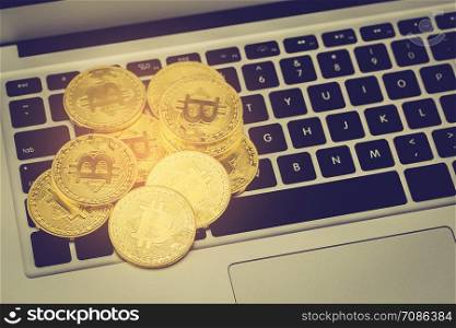 Bitcoin on laptop computer, gold coin with currency digital exchange cash with crypto, technology about money, commercial and finance concept.
