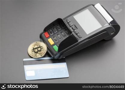 Bitcoin,POS-terminal and credit card.business concept over black