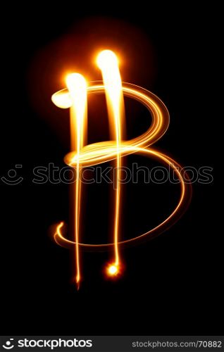 Bitcoin sign over black background - light painting