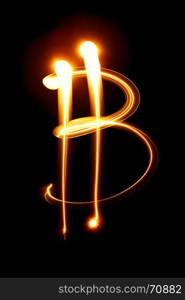 Bitcoin sign over black background - light painting