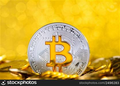 Bitcoin stand in pile on golden coins