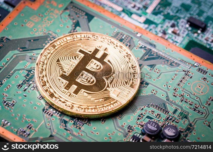 Bitcoin, the digital currency in studio on motherboard background