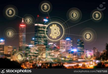Bitcoins and blockchain network connection with blur Perth night city background .Electronic money ,blockchain transfers and finance concept.