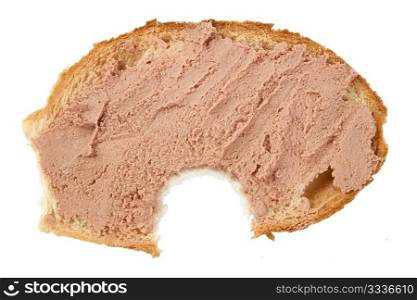 bitten slice of bread with pate on white background