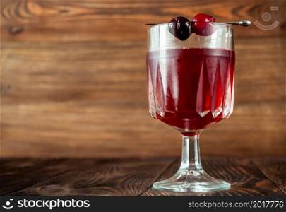 Bitter Jean Cocktail garnished with maraschino cherries