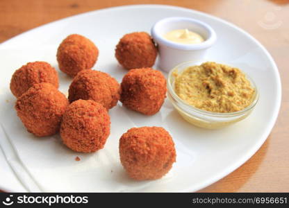 Bitterballen with mustard, warm fried snack, served in the Netherlands. Dutch fried snack: bitterballen