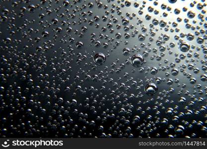 Black abstract background with air bubbles. Bubbles texture on black.