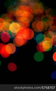 Black abstract background with colorful blurred lights