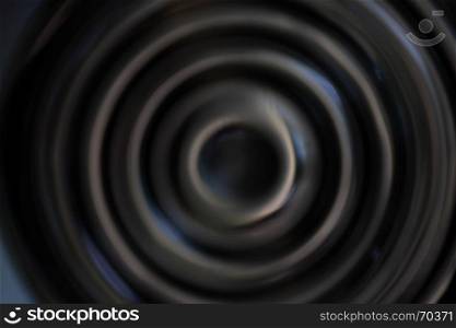 Black abstract background with defocused concentric circles