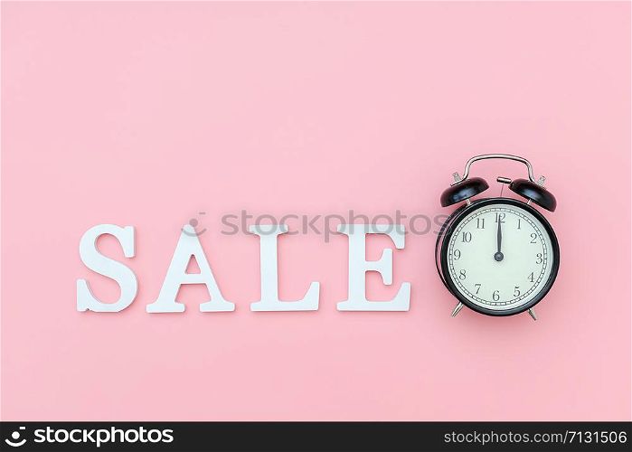 Black alarm clock and text Sale from white volume letters on a pink background. Concept Black friday , sales time. Flat lay Top view Copy space Template for design.. Black alarm clock and text Sale from white volume letters on a pink background. Concept Black friday , sales time. Flat lay Top view Copy space Template for design