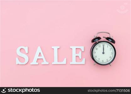 Black alarm clock and text Sale from white volume letters on a pink background. Concept Black friday , sales time. Flat lay Top view Copy space Template for design.. Black alarm clock and text Sale from white volume letters on a pink background. Concept Black friday , sales time. Flat lay Top view Copy space Template for design