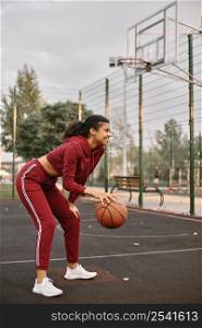 black american woman playing basketball field