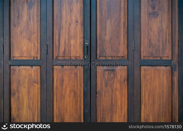 ?Black and brown old wooden folding doors.