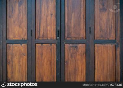 ?Black and brown old wooden folding doors.