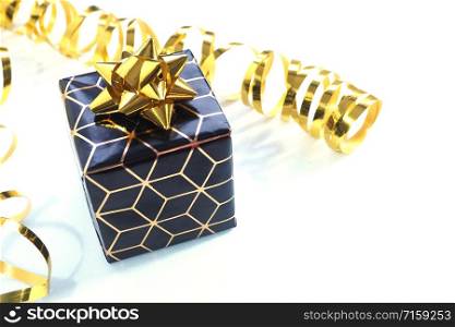 black and gold gift box with a gold bow and gold serpentine on a white background.