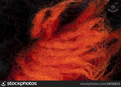 Black and red wool fibers closeup