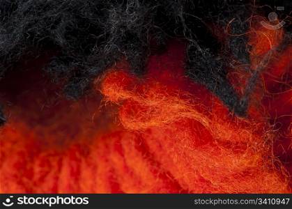 Black and red wool fibers closeup