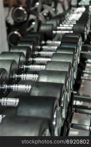 Black and Steel Dumbbells in Gym: Weight Fitness Equipment