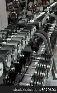 Black and Steel Dumbbells in Gym: Weight Fitness Equipment