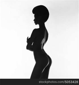 Black and white art fashion studio photo of nude elegant woman on white background. Perfect body. Beauty and health