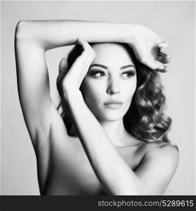 Black and white art portrait of beautiful sensual woman with elegant hairstyle on gray background
