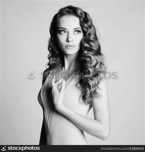 Black and white art portrait of beautiful sensual woman with elegant hairstyle on gray background
