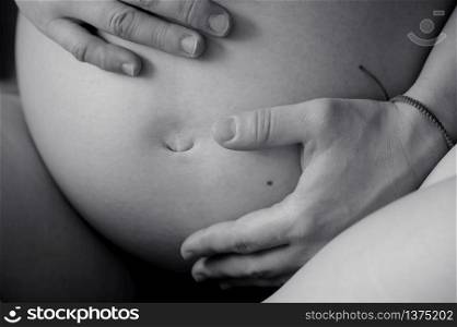 Black and white belly of pregnant woman closeup, nine month. Belly of pregnant woman, nine month
