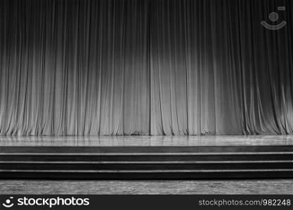 Black and white curtains and the stage parquet with stairs in theater.